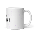 Taza ZOMKI Crew blanca con confeti lila, vista lateral con el asa a la derecha