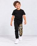 Modelo sintético generado con IA: jogger negro ZOMKI Graffiti Dorado, estampado vertical en la pierna izquierda; camiseta de estilismo no incluida